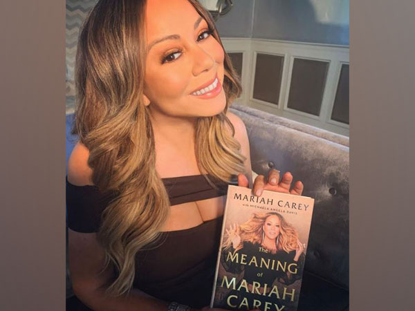 Mariah Carey with her autobiography 'The Meaning of Mariah Carey' (Image Source: Instagram)