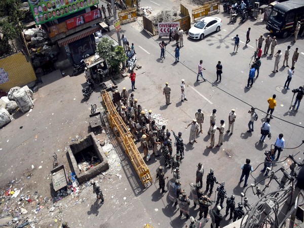 Police stand guard in Jahangirpuri on April 17 after clashes broke out between two communitites. (Photo/ANI)