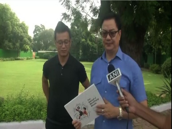 Union Minister for Youth Affairs and Sports Kiren Rijiju with Baichung Bhutia in New Delhi on Friday.