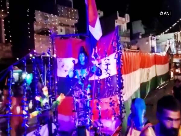 Pilgrims carrying the 151-feet-long national flag.