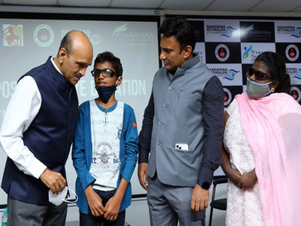 Karnataka Health Minister Dr K Sudhakar checking on young boy's vision as Dr K Bhujang Shetty, CMD of Narayana Nethralaya looks on, during inauguration of National programme on eye donation.