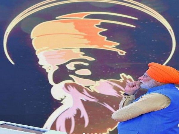 Prime Minister Narendra Modi posing before Guru Nanak Dev's painting in Punjab. Photo/ANI