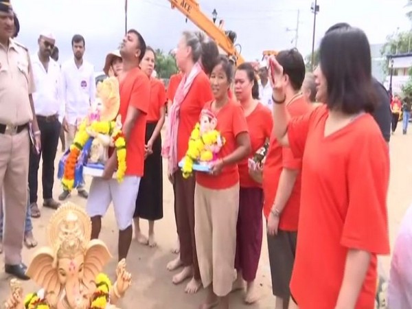 Foreign nationals at Juhu beach in Mumbai on Thursday to take part in the immersion of Lord Ganesha. Photo/ANI