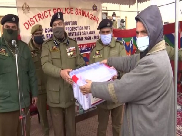 Srinagar SSP Dr. Haseeb Mughal distributing COVID-19 safety kits during an awareness camp on Friday. Photo/ANI