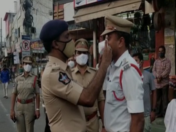 Guntur SP Ammi Reddy making Circle Officer Mallikarjuna Rao wear a mask. [Photo/ANI] 