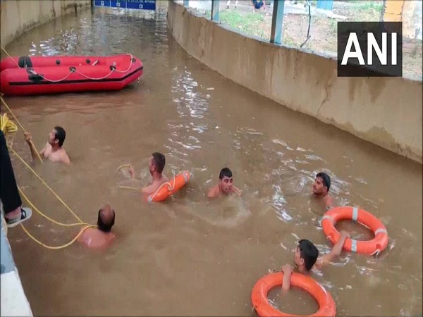 Rescue teams searching for the body of the man who drowned in the waterlogged underpass.