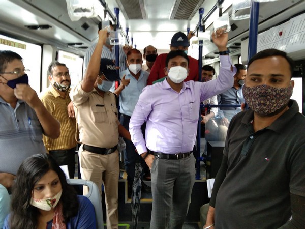 Dehradun DM R Rajesh Kumar travelling with passengers in Smart City Limited Bus. (Photo/ANI)