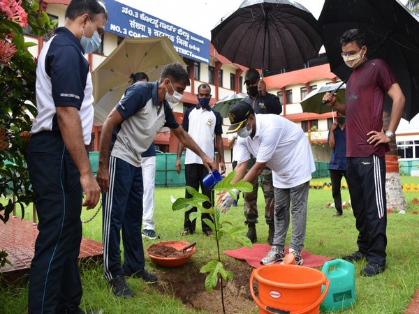 Indian Coast Guard personnel plant saplings.