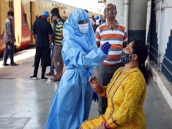 BMC health worker collects a nasal sample from a passenger for Covid Antigen test at Dadar station, in Dadar on Sunday. (Photo/ANI))