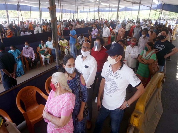 People wait in long queues for their turn to receive a covid-19 vaccine. (Photo/ANI)