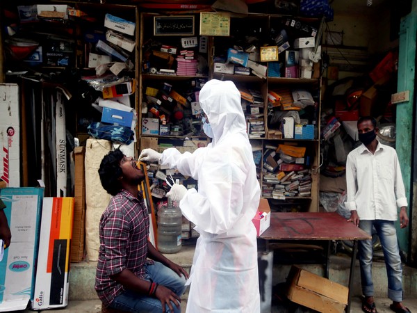 A medic wearing a PPE kit takes a swab sample of a man for the COVID-19 testing amid the surge in cases, in Chennai. (Photo/ANI )
