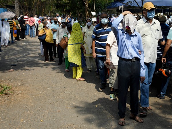 People wait in line to get a dose of COVID-19 vaccine. (File Photo/ANI)