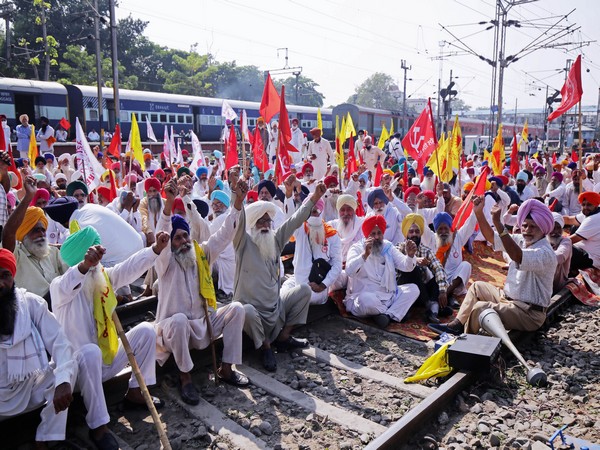 Farmers raise slogans as they sit on railway tracks during the 'rail roko' protest. [File Photo/ANI]
