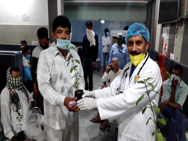 Dr CP Singh (left) giving plant to the patients on World Environment Day (Photo/ANI)