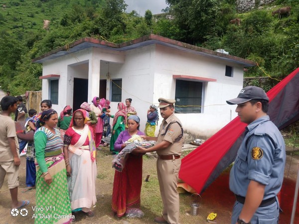 Police distributed relief material in Chamoli on Wednesday. Photo/ANI