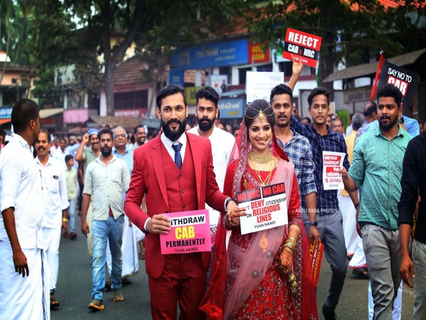 Newly-married couple holding Anti-CAA, NRC placards to mark their protest in Kerala. Photo/ANI