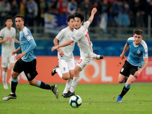 Players in action in the match between Japan and Uruguay