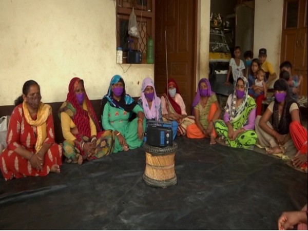 Women listing to community raido