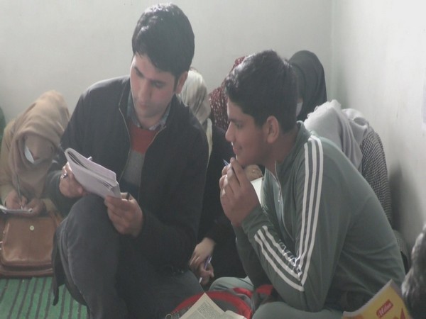 Malik Mukhtar teaching calligraphy to a student at his institute in Baramulla. 