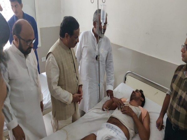 UP Deputy Chief Minister Dinesh Sharma meeting an injured passenger at a hospital in Agra on Monday. Photo/ANI