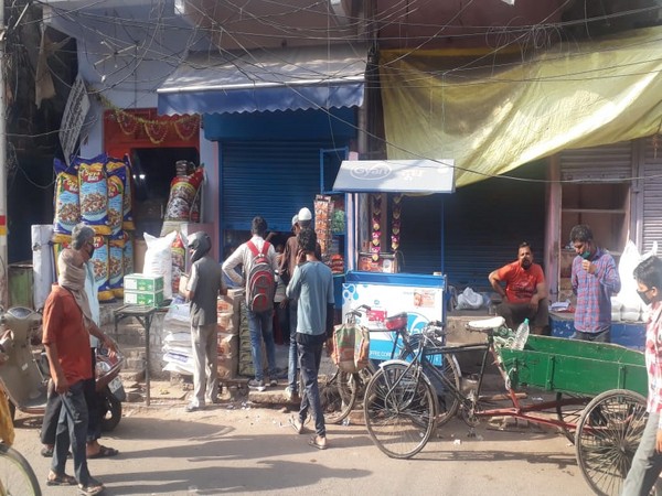Customers lined up at a market in Prayagraj to buy essential commodities on Tuesday. [Photo/ANI]