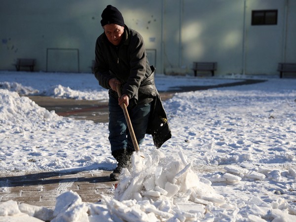 A worker clears snow at a park during winter solstice in Beijing, China (Photo Credits: Reuters)