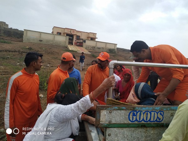NDRF personnel taking pregnant woman to the hospital in Gujarat on Thursday. Photo/ANI