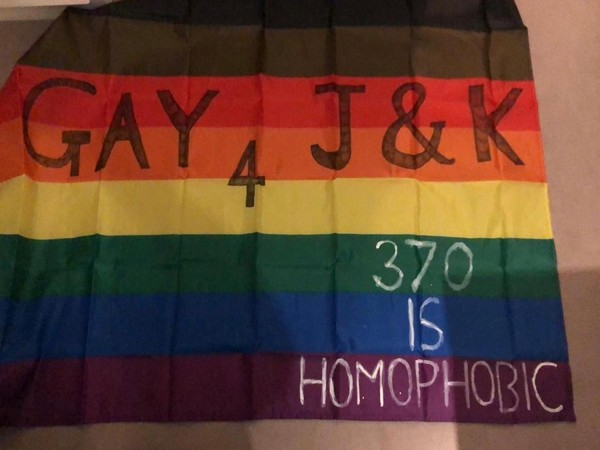 The flags carried by the volunteers read -- GAY 4 J&K.