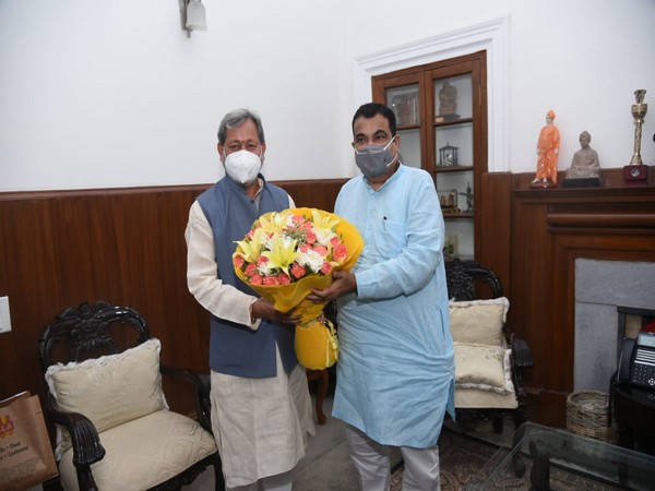 Uttarakhand Chief Minister Tirath Singh Rawat greeting Union Road Transport Minister Nitin Gadkar. i
