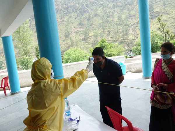 People coming to Uttarakhand from different states are being screened at Bilona Bus Stand in Bageshwar. Photo/ANI