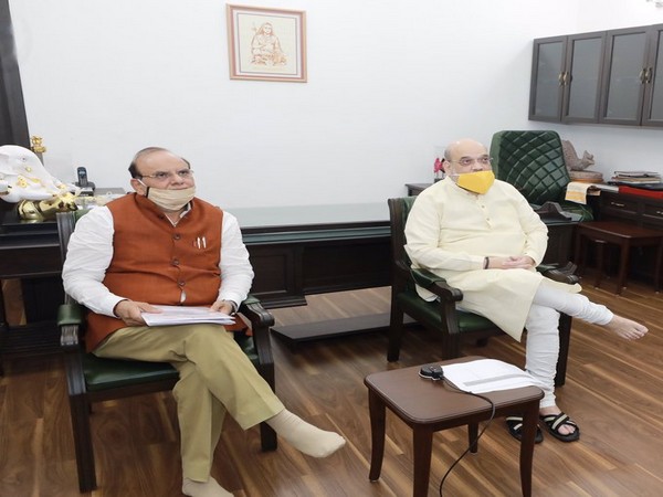 Union Home Minister Amit Shah with KVIC Chairman Vinai Kumar Saxena interacting with potters via video conferencing