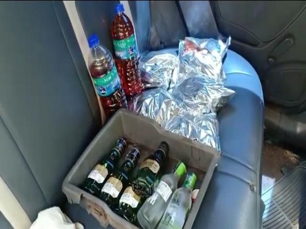 Police detains man, seizes car with liquor bottles and chicken hidden in it. Photo/ ANI