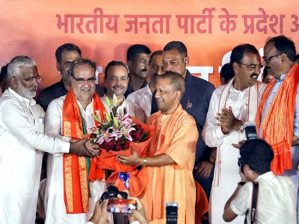 UP CM Yogi Adityanath welcomes the newly appointed State BJP chief Bhupendra Chaudhary with a bouquet (File Photo) 