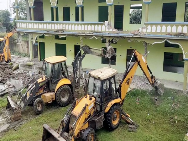 JCB machines demolish the Markazul Ma-Arif Quariayana Madrasa (Photo/ANI) 