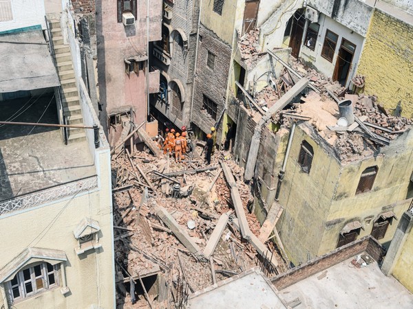 Debris being cleared from the site where an under-construction four-storey building collapsed in New Delhi's Azad Market (Photo/ANI)
