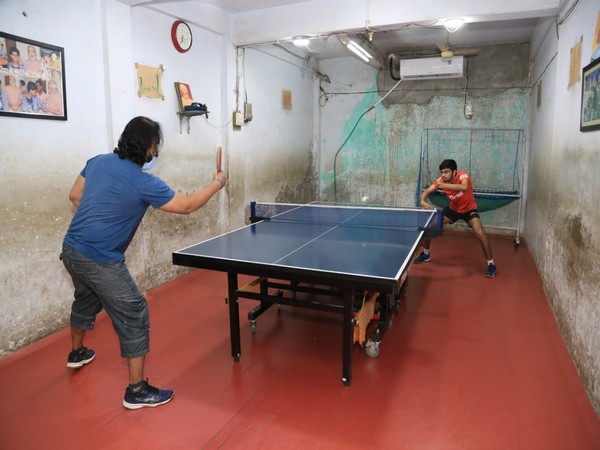 Manav Thakkar practicing table-tennis in basement room