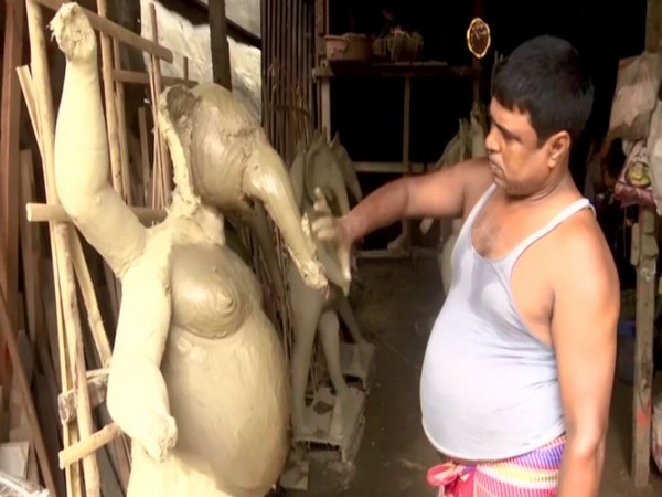 An artisan busy making the idol in Guwahati