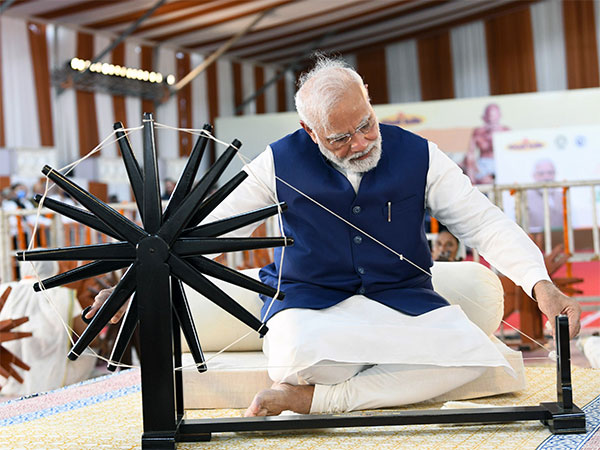 PM Narendra Modi spinning 'Charkha' in Khadi Utsav at the Sabarmati River Front, in Ahmedabad on August 27 (ANI Photo/PIB)