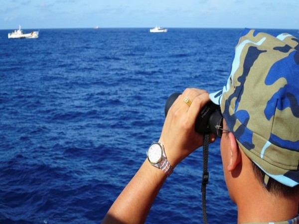 A crewman from Vietnamese coastguard ship 8003 looks out at sea as Chinese coastguard vessels in South China Sea. (Photo Credit - Reuters)