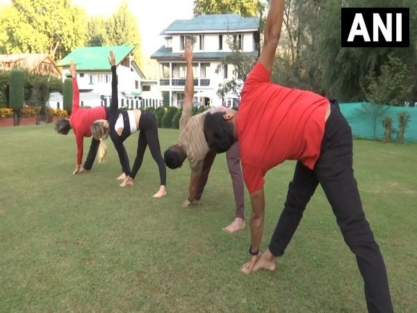 Yoga professionals from Singapore doing exercises (Photo/ANI)