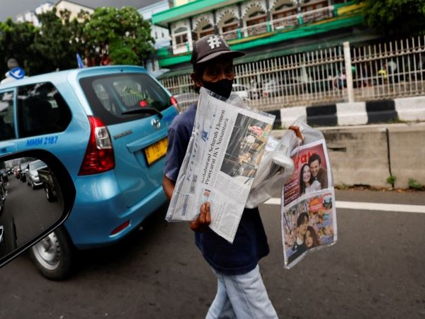 A street vendor sells papers with the news of Indonesian New Capital Nusantara on its headline in Jakarta. (Photo Credit - Reuters)