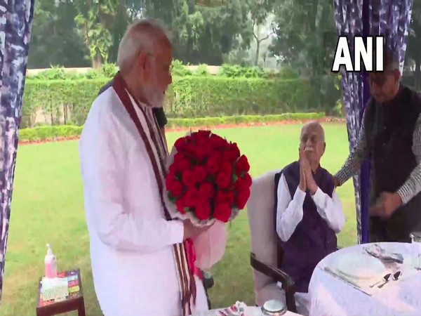 Prime Minister Narendra Modi visits the residence of senior BJP leader LK Advani to greet him on his birthday. (Photo/ANI)