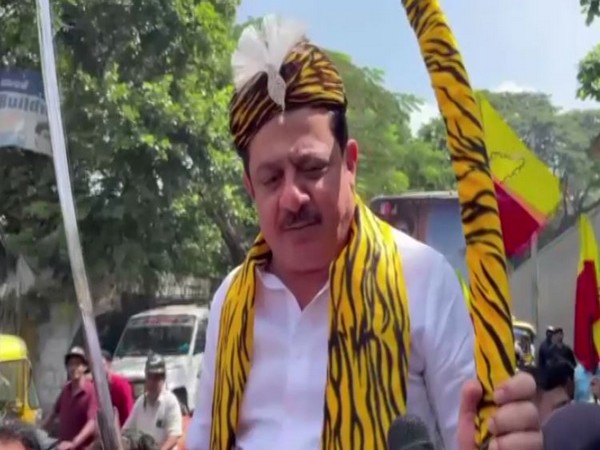 Congress MLA Zameer Ahmed Khan talks to media on Thursday holding a sword. (ANI/Photo)