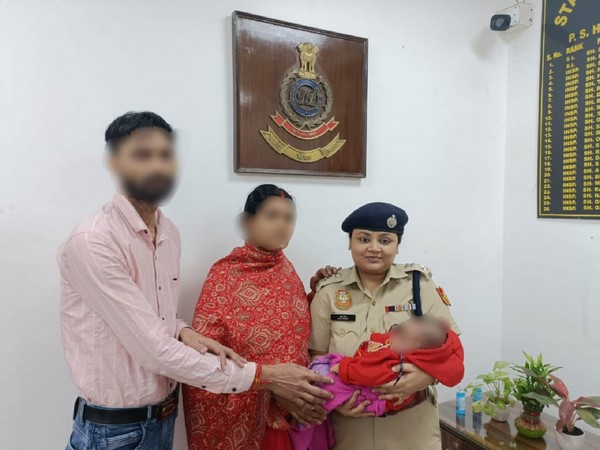 Delhi DCP (South East) Esha Pandey handing over the parents a two-month-old boy after rescuing him from the kidnapped woman. 