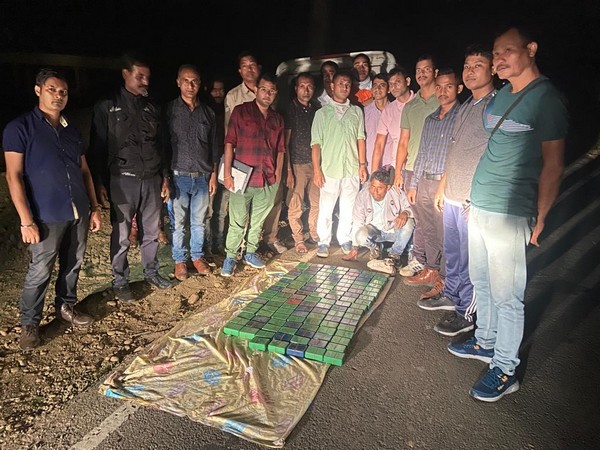 Assam police with seized drugs. (Photo/ANI)