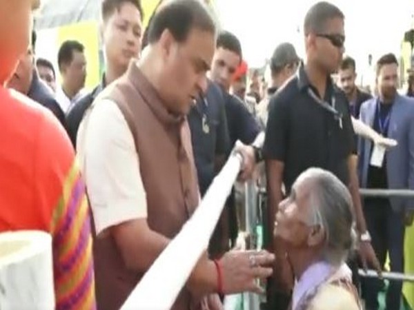 Assam CM Himanta Biswa Sarma interacting with the elderly woman. (ANI/Photo)