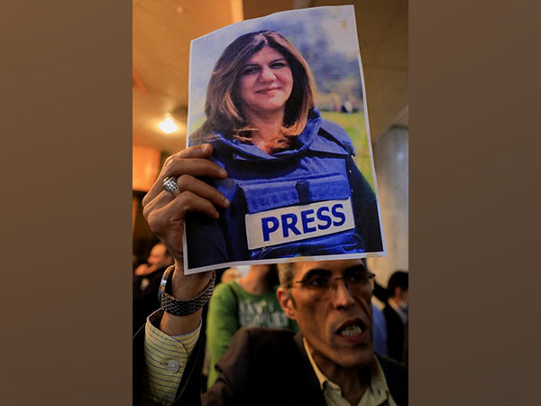 A man holds picture of late Al Jazeera journalist Shireen Abu Akleh (Photo Credit - Reuters)