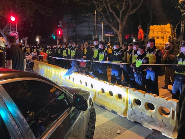 Police officers stand behind barricades and cordon in Shanghai. (Photo Credit - Reuters)