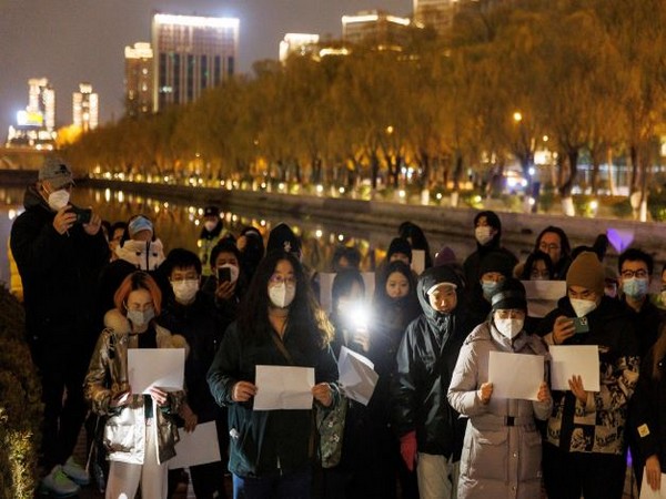 Vigil commemorating victims of a fire in Urumqi, Beijing. (Image Credit: Reuters)