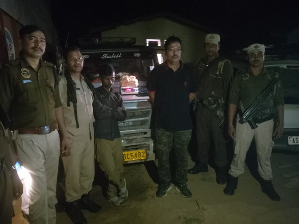 Assam Police with the arrested drug peddler. (ANI/photo)